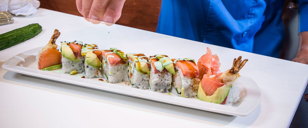 Chef preparing sushi rolls