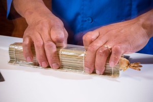 A Chef Decorating a Sushi Roll